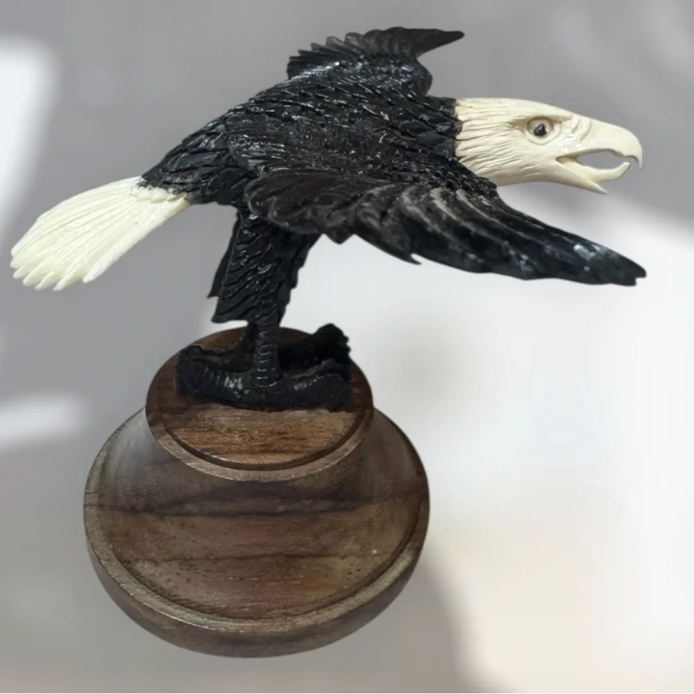 Alaskan bone carved eagle in flight on wood base 4”